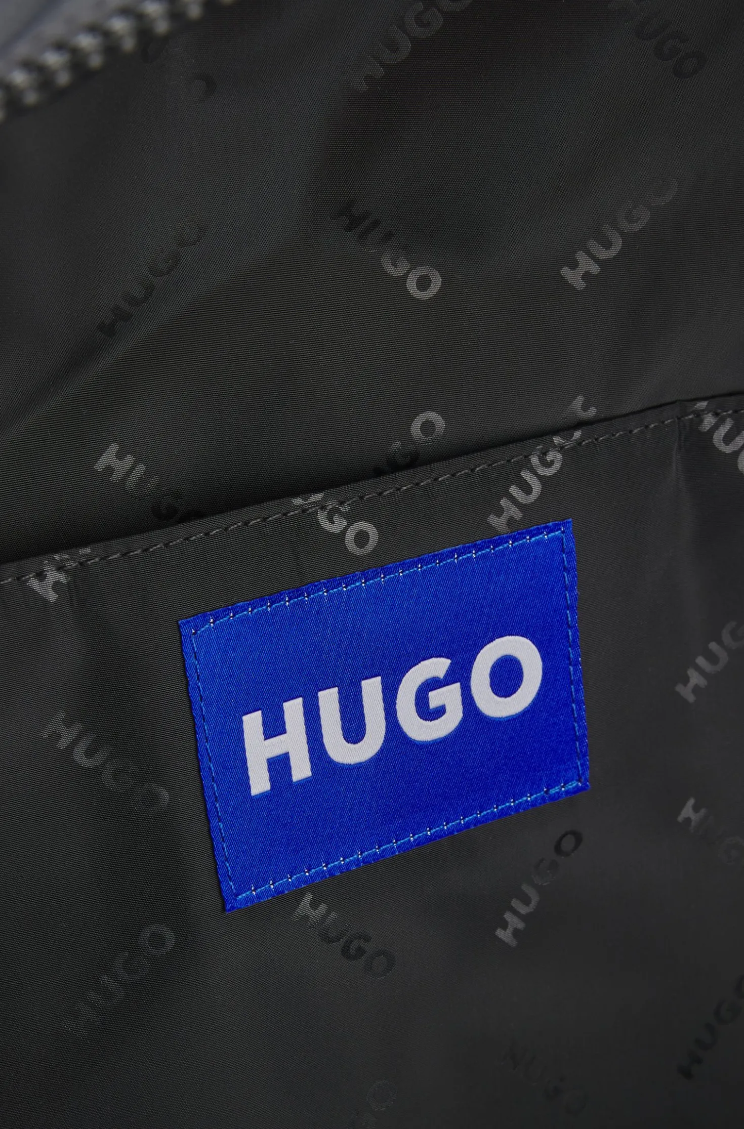 Backpack with blue rubber logo patch