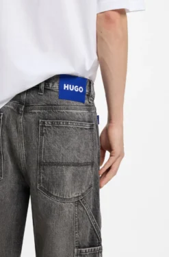 Baggy-fit black jeans with carpenter details