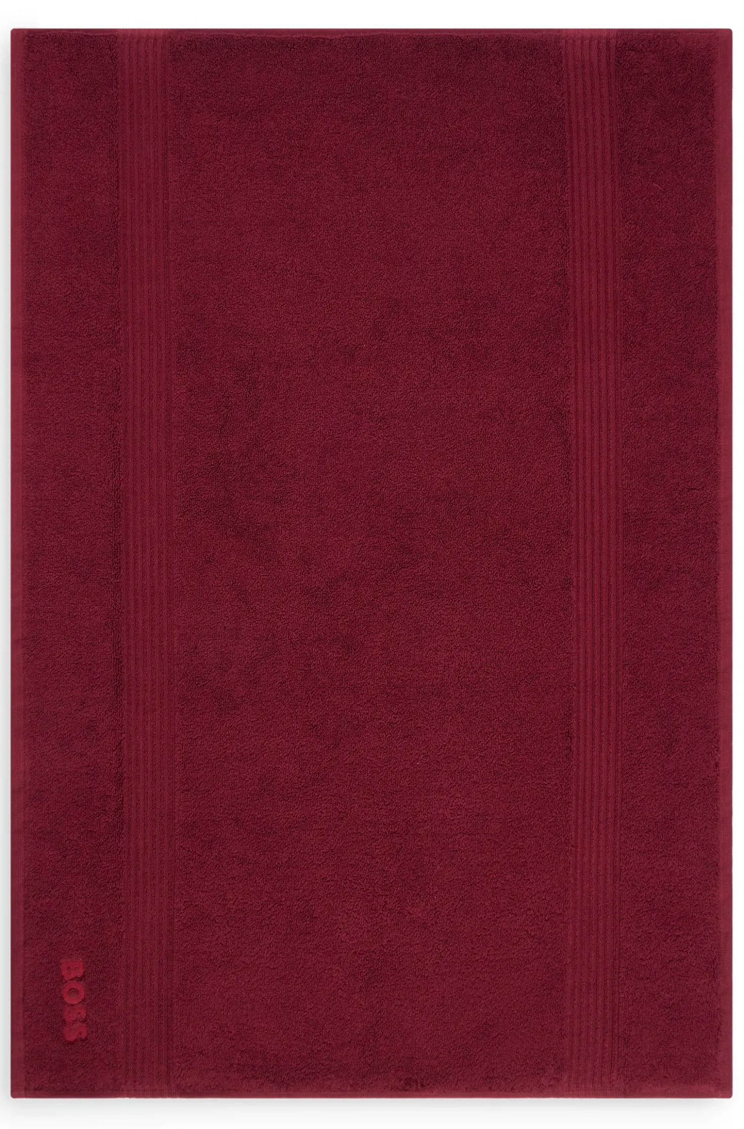 Cotton bath mat with embroidered logo