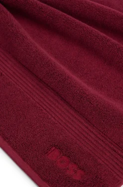Cotton bath mat with embroidered logo