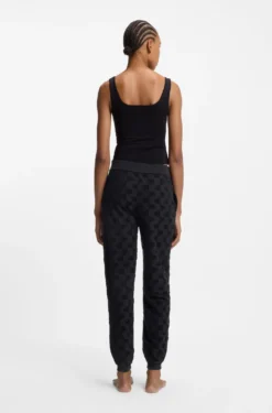 Cotton-blend tracksuit bottoms with all-over logo pattern