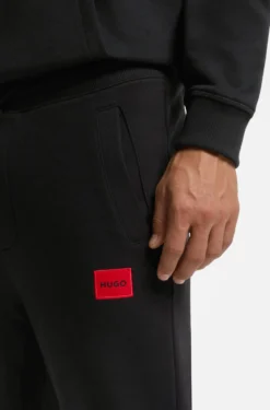 Cotton-terry tracksuit bottoms with red logo label