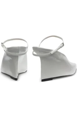 Glossy leather mules with wedge heel and strap