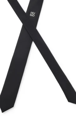 Jacquard-woven tie with metallic stacked-logo trim