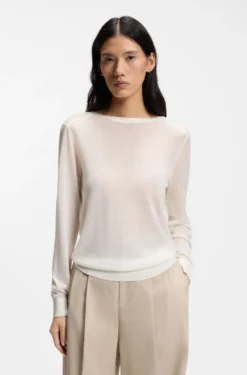 Knitted cardigan with rear button closure