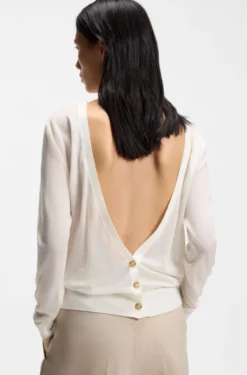 Knitted cardigan with rear button closure