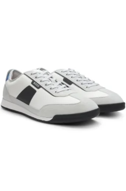 Mixed-material trainers with ridged outsole