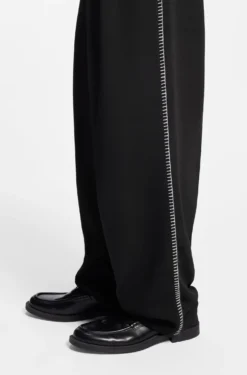 Pleat-front trousers with whipstitch details