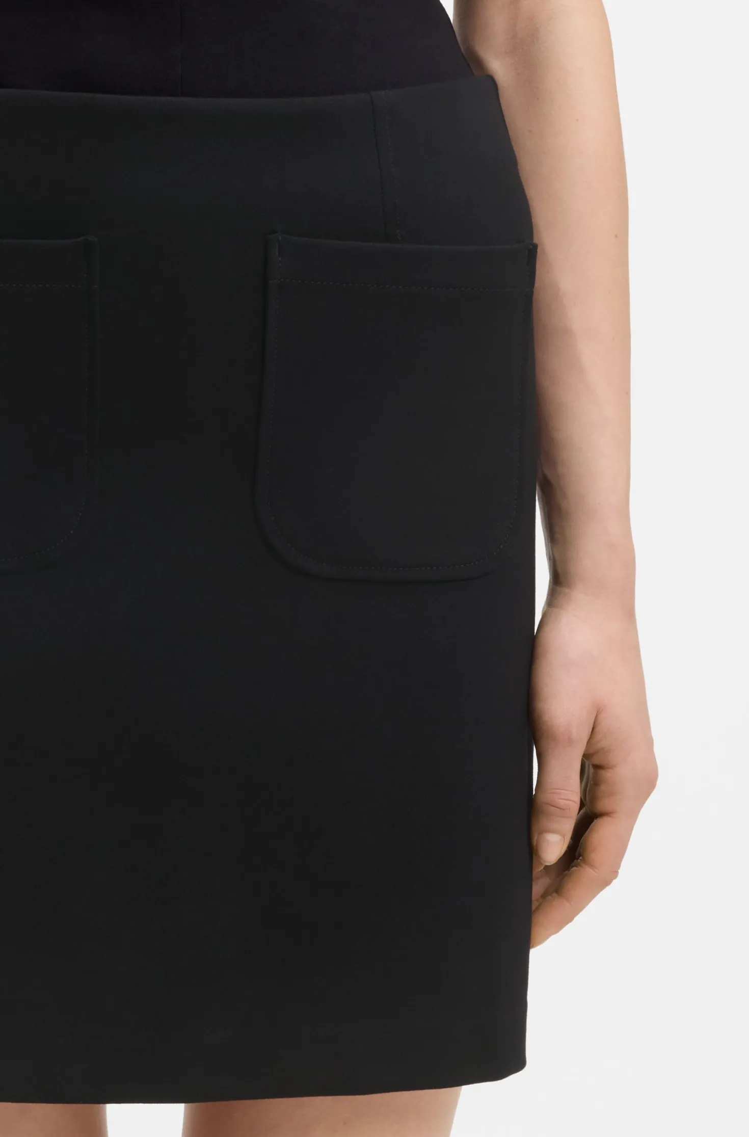 Punto Milano jersey mini skirt with front pockets