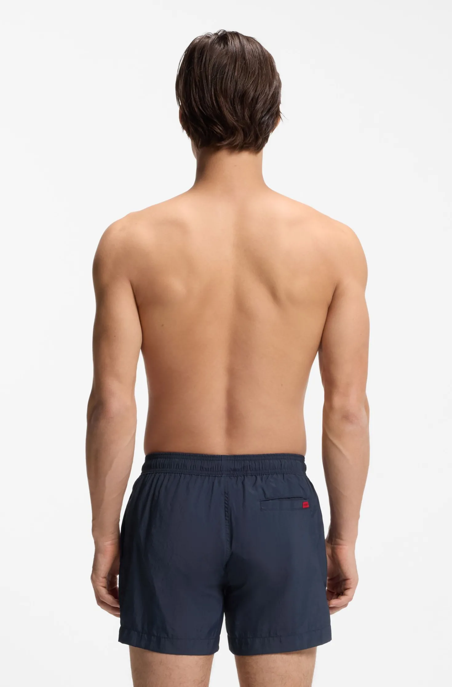 Quick-drying swim shorts with red logo label