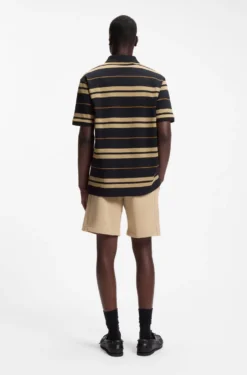 Regular-fit polo in cotton piqué with engineered stripes