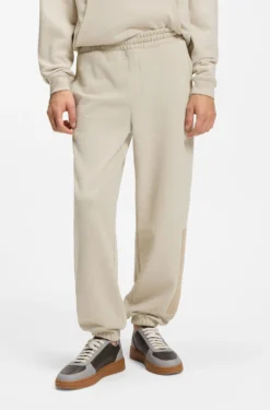 Relaxed-fit tracksuit bottoms in cotton with logo trim