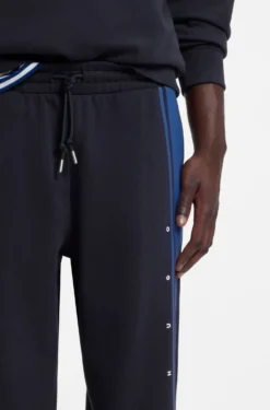 Relaxed-fit tracksuit bottoms in cotton with side stripe