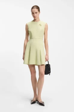 Sleeveless dress with gold-tone flower brooch