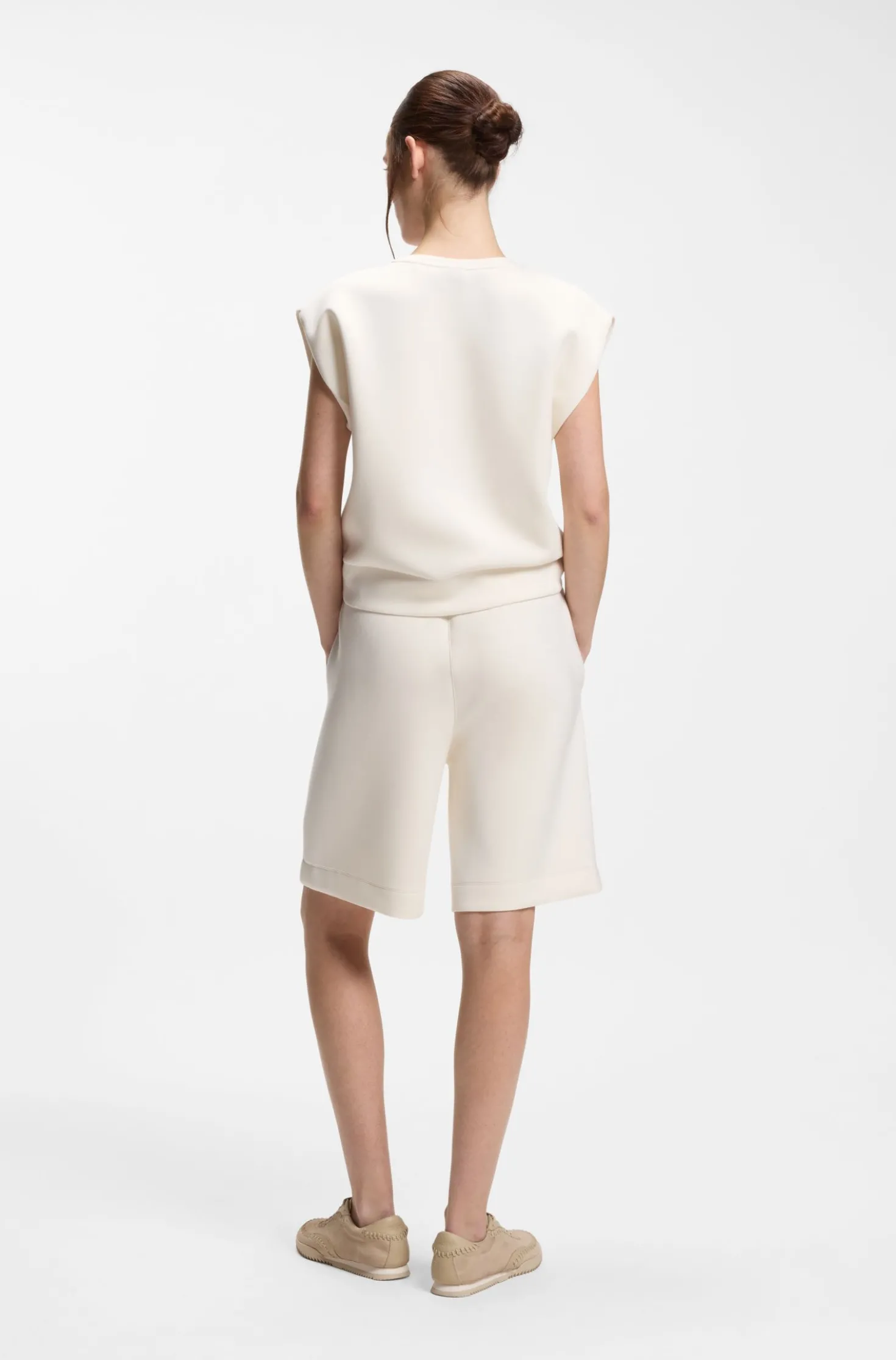 Sleeveless loose-fit sweatshirt with V-cut hemline