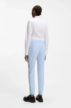 Slim-fit trousers in stretch fabric with logo rivet