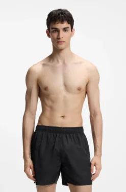Swim shorts with all-over stacked logos