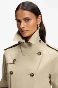 Water-repellent trench coat with buckled belt